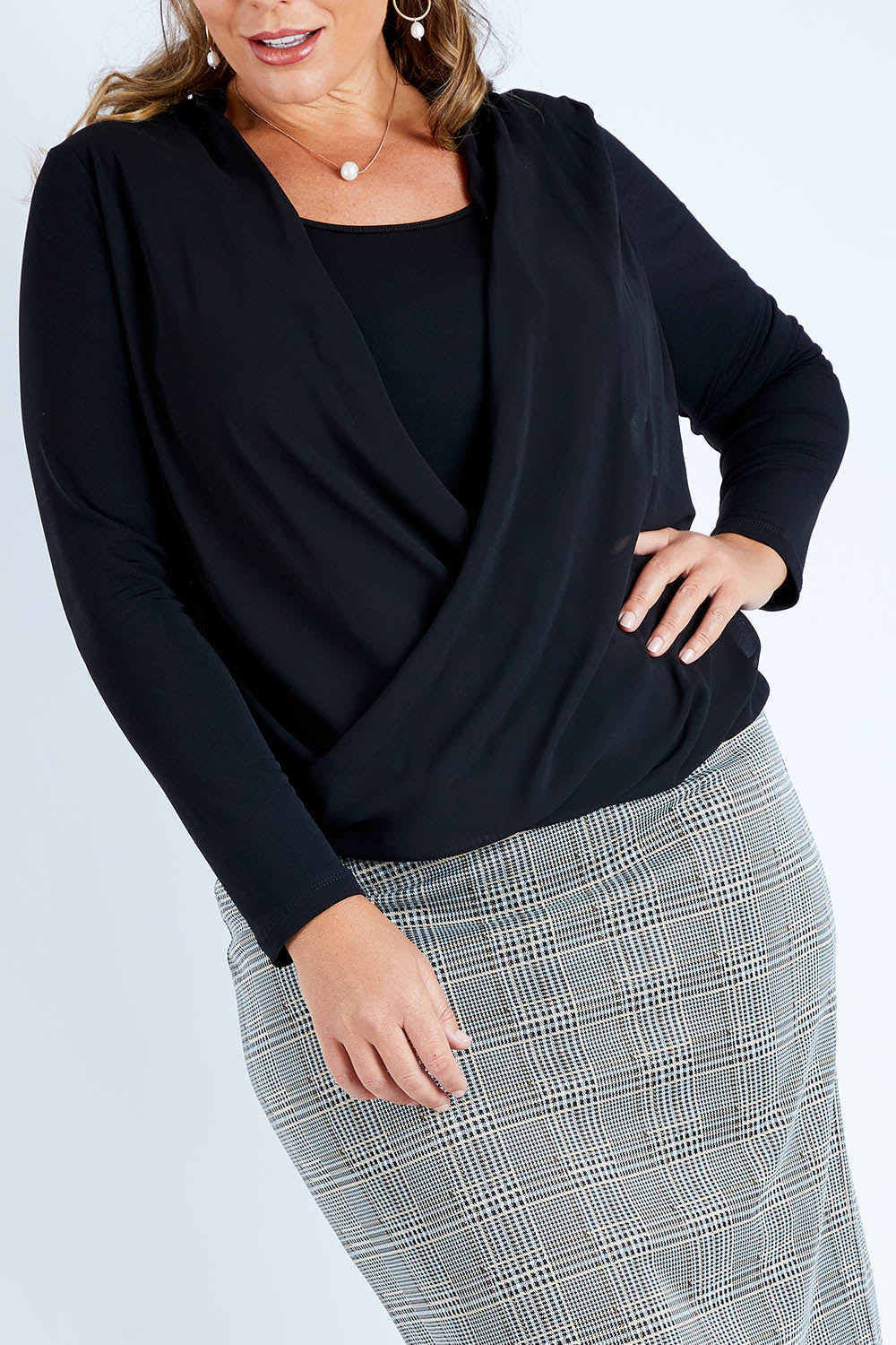 Model Fiona wearing size 16 of The Faux 2 Piece Crossover Top in colour Black (Black), from the front, cropped image