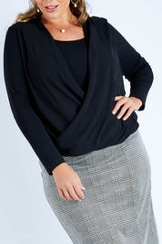 Model Fiona wearing size 16 of The Faux 2 Piece Crossover Top in colour Black (Black), from the front, cropped image