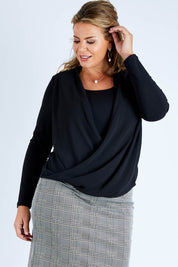 Model Fiona wearing size 16 of The Faux 2 Piece Crossover Top in colour Black (Black), from the front, cropped image