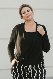 Model Fiona wearing size 16 of The Faux 2 Piece Crossover Top in colour Black (Black), from the front, showing the whole outfit