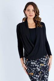 Model Madeline wearing size 10 of The Faux 2 Piece Crossover Top in colour Black (Black), from the front, cropped image