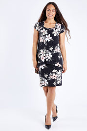 Model Larissa wearing size 10 of The Printed Short Sleeve Rita Dress in colour Pinkfleur (Black), from the front, showing the whole outfit