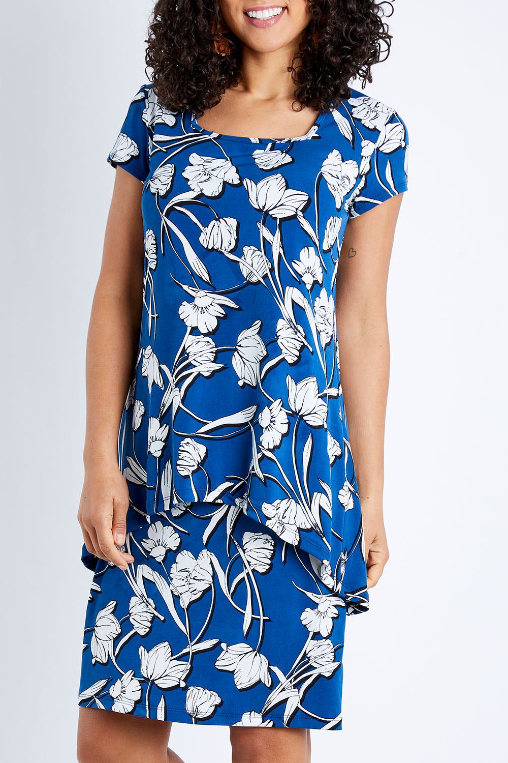 Model Pamela wearing size 10 of The Printed Short Sleeve Rita Dress in colour Floral (Blue), from the front, cropped image