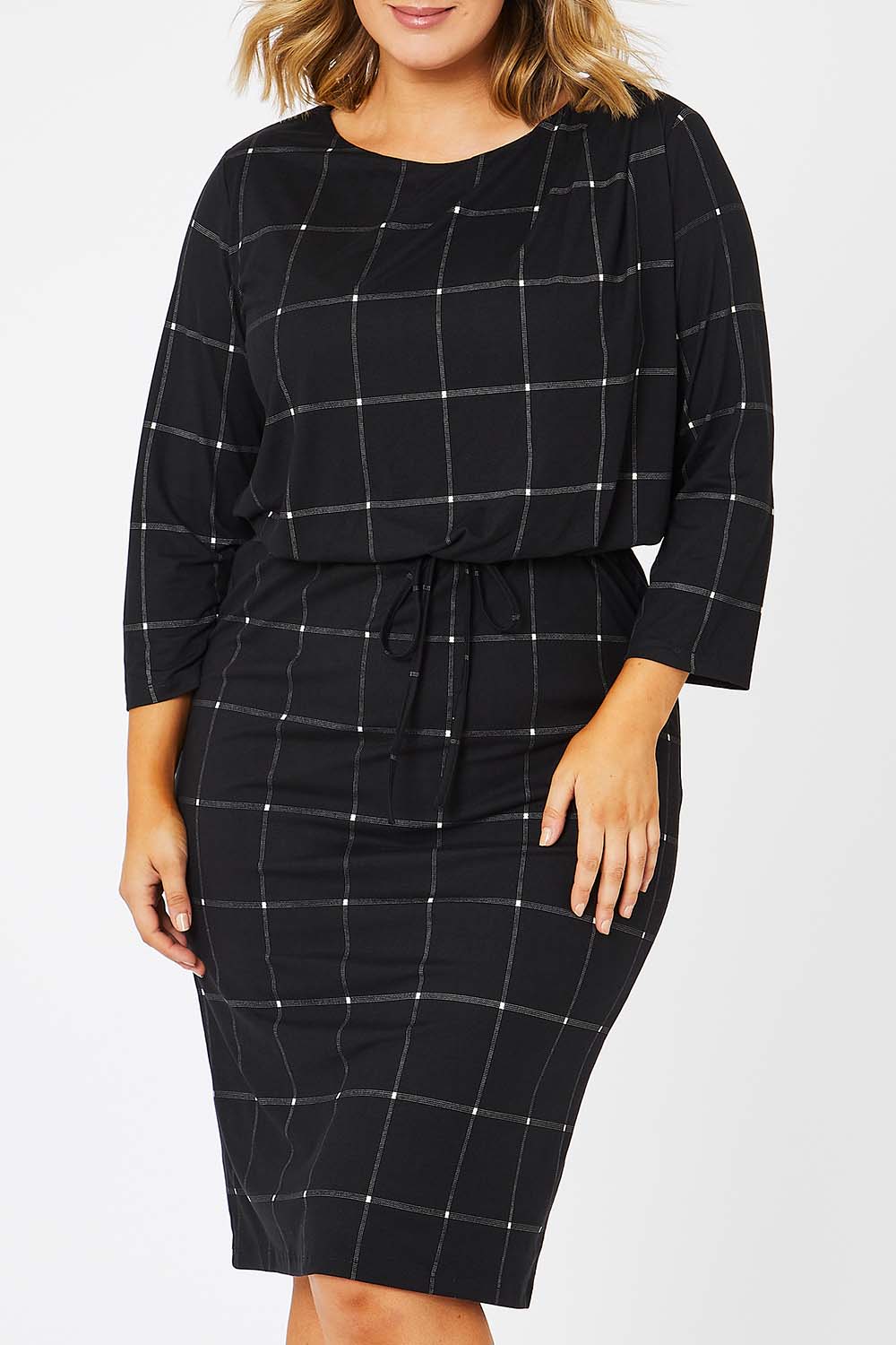 Model Jess wearing size 14 of The Lined Jersey Dress in colour Checks (Black), from the front, cropped image