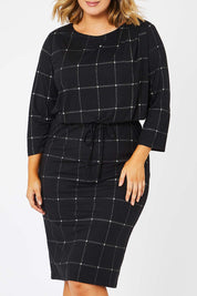 Model Jess wearing size 14 of The Lined Jersey Dress in colour Checks (Black), from the front, cropped image
