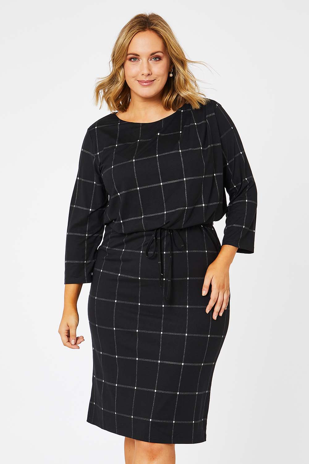 Model Jess wearing size 14 of The Lined Jersey Dress in colour Checks (Black), from the front, cropped image