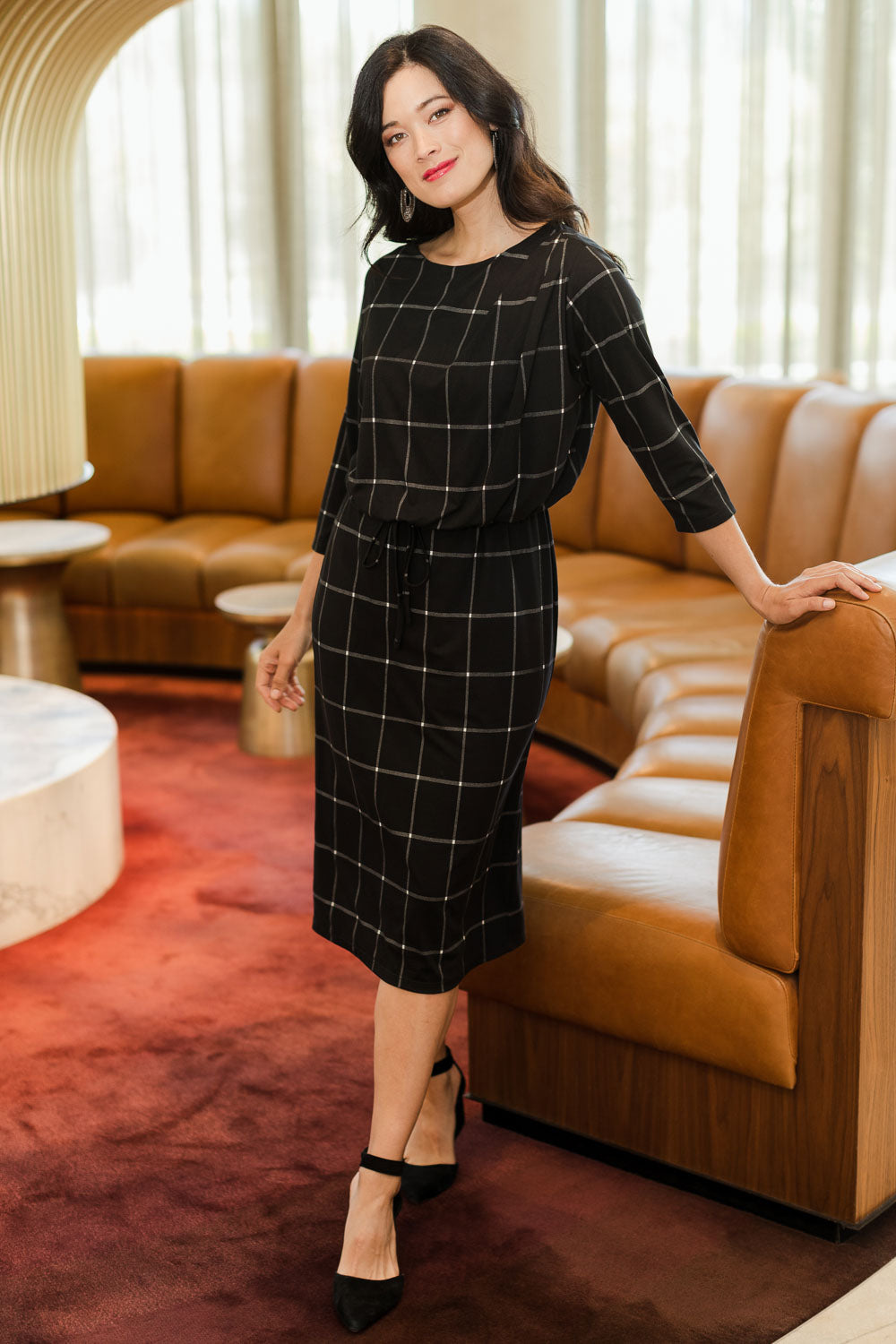 Model Miranda wearing size 10 of The Lined Jersey Dress in colour Checks (Black), from the front, showing the whole outfit