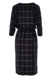 Product shot of The Lined Jersey Dress in colour Checks (Black), from the back