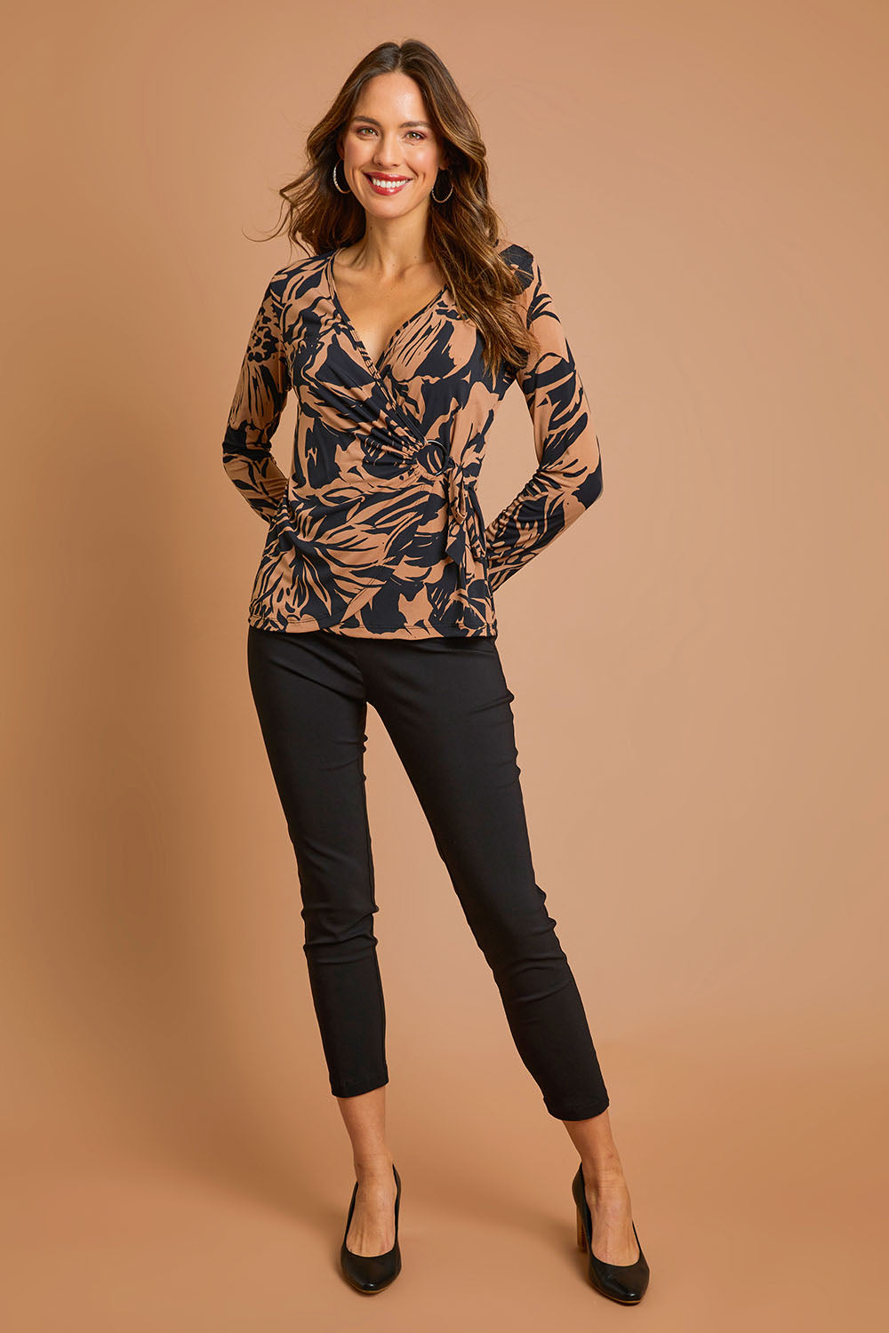 Model Madeline wearing size 10 of The Stretch Career Pull On Pant in colour Black (Black), from the front, showing the whole outfit