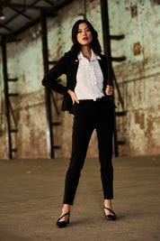 Model Miranda wearing size 10 of The Stretch Career Pull On Pant in colour Black (Black), from the front, showing the whole outfit