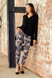 Model Cara wearing size 10 of The Printed Pull On Pant in colour Zebra (Black), from the front, showing the whole outfit
