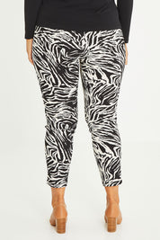 Model Palatina wearing size 16 of The Printed Pull On Pant in colour Zebra (Black), from the back