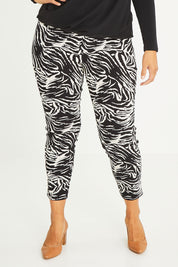 Model Palatina wearing size 16 of The Printed Pull On Pant in colour Zebra (Black), from the front, cropped image