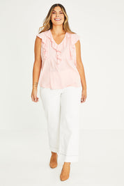 Model Palatina wearing size 16 of The Flowy Ruffle Top in colour Pink (Pink), from the front, showing the whole outfit
