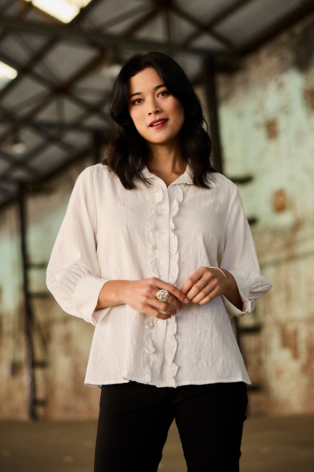 Model Miranda wearing size 10 of The Frill Placket Cotton Dobby Shirt in colour White (White), from the front, showing the whole outfit