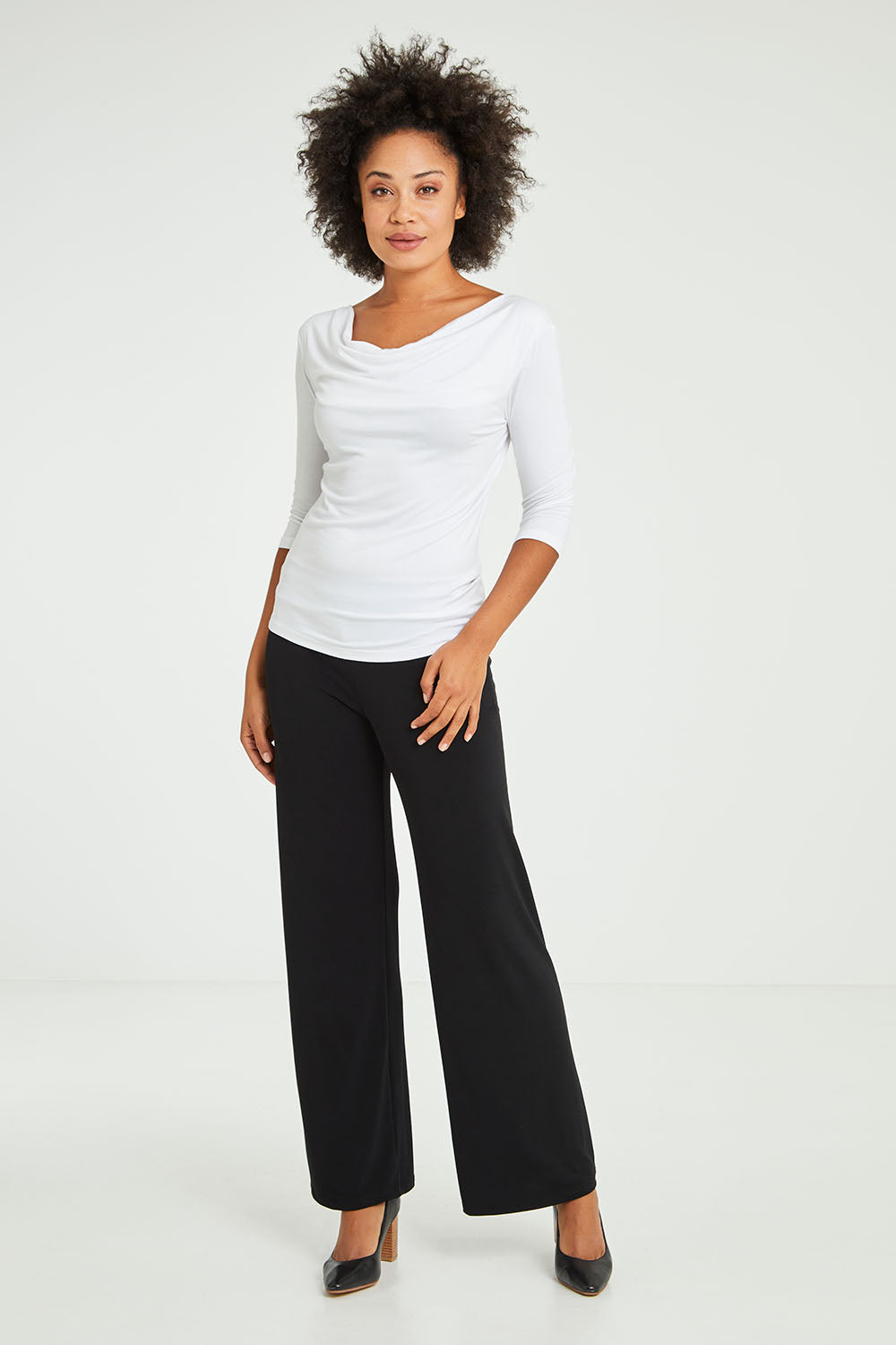 Model Olivia wearing size 10 of The Essential Jersey Pull On Pant in colour Black (Black), from the front, showing the whole outfit