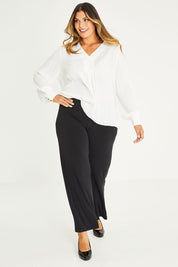 Model Palatina wearing size 16 of The Essential Jersey Pull On Pant in colour Black (Black), from the front, showing the whole outfit