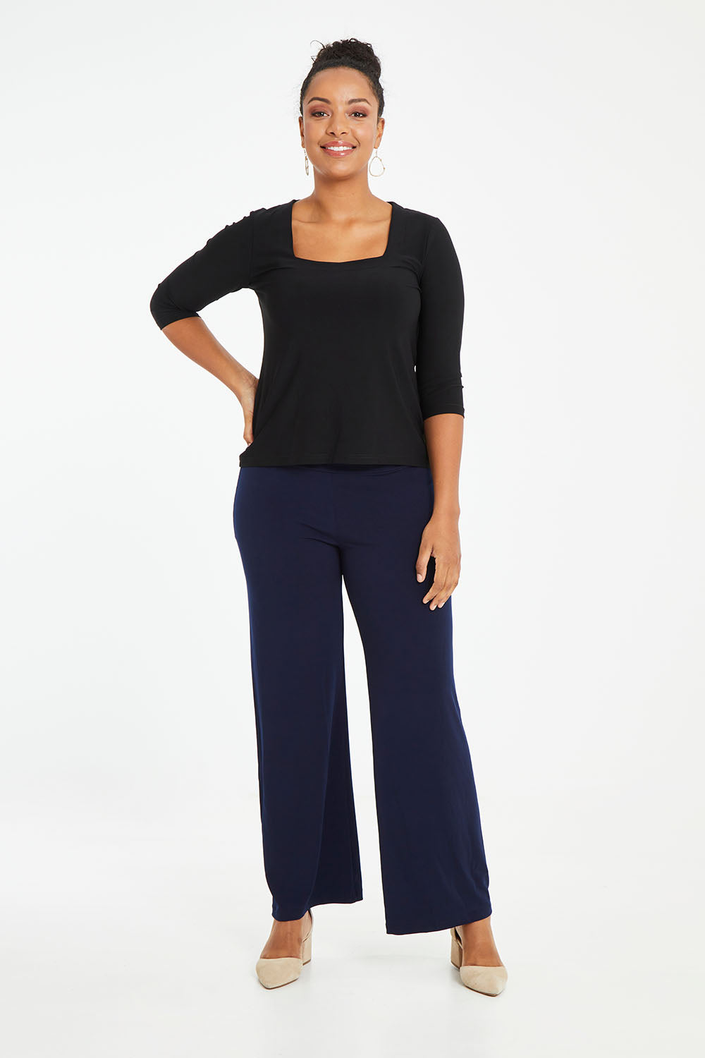 Model Noli wearing size 14 of The Essential Jersey Pull On Pant in colour Navy (Blue), from the front, showing the whole outfit