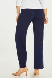 Model Stacey wearing size 10 of The Essential Jersey Pull On Pant in colour Navy (Blue), from the back