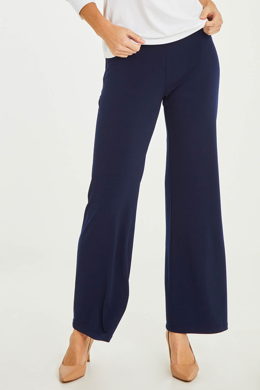 Model Stacey wearing size 10 of The Essential Jersey Pull On Pant in colour Navy (Blue), from the front, cropped image