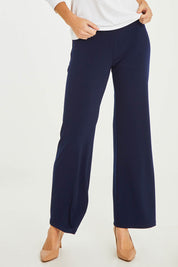 Model Stacey wearing size 10 of The Essential Jersey Pull On Pant in colour Navy (Blue), from the front, cropped image