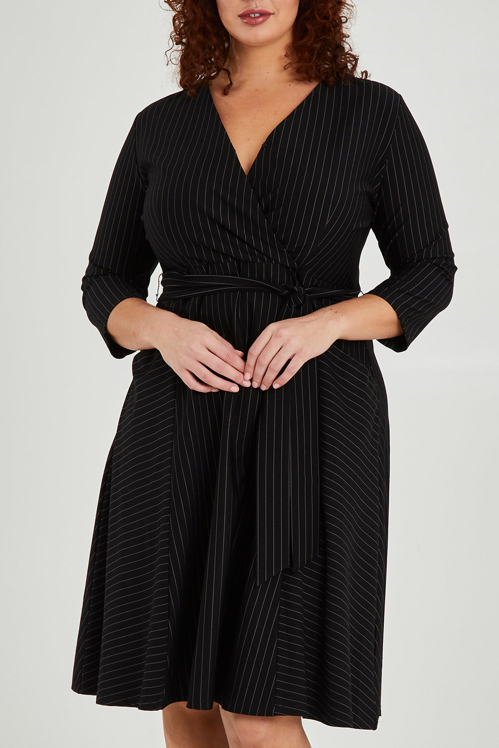 Model Maddy wearing size 16 of The Stripe Ponte Pocket Dress in colour Stripe (Black), from the front, cropped image