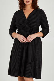 Model Maddy wearing size 16 of The Stripe Ponte Pocket Dress in colour Stripe (Black), from the front, cropped image
