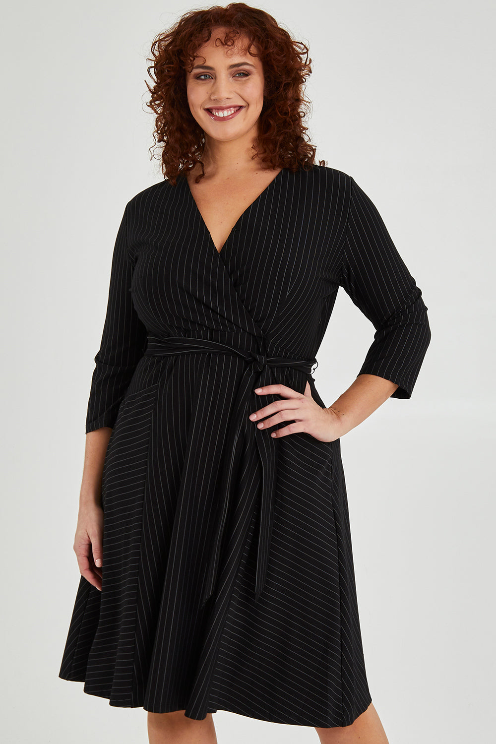 Model Maddy wearing size 16 of The Stripe Ponte Pocket Dress in colour Stripe (Black), from the front, cropped image