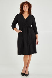 Model Maddy wearing size 16 of The Stripe Ponte Pocket Dress in colour Stripe (Black), from the front, showing the whole outfit