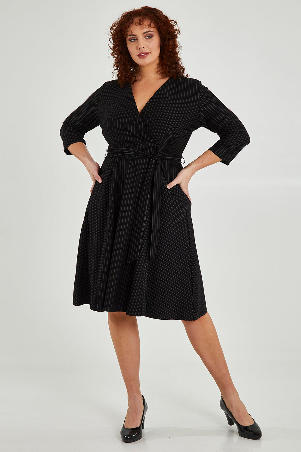 Model Maddy wearing size 16 of The Stripe Ponte Pocket Dress in colour Stripe (Black), from the front, showing the whole outfit