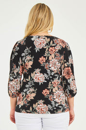 Model Katie wearing size 16 of The Knot Waist Detail Blouse in colour Blackfleur (Black), from the back