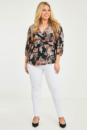 Model Katie wearing size 16 of The Knot Waist Detail Blouse in colour Blackfleur (Black), from the front, showing the whole outfit