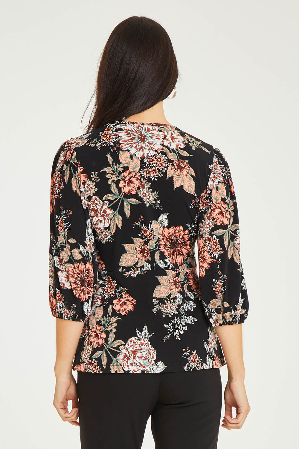 Model Stacey wearing size 10 of The Knot Waist Detail Blouse in colour Blackfleur (Black), from the back