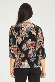 Model Stacey wearing size 10 of The Knot Waist Detail Blouse in colour Blackfleur (Black), from the back