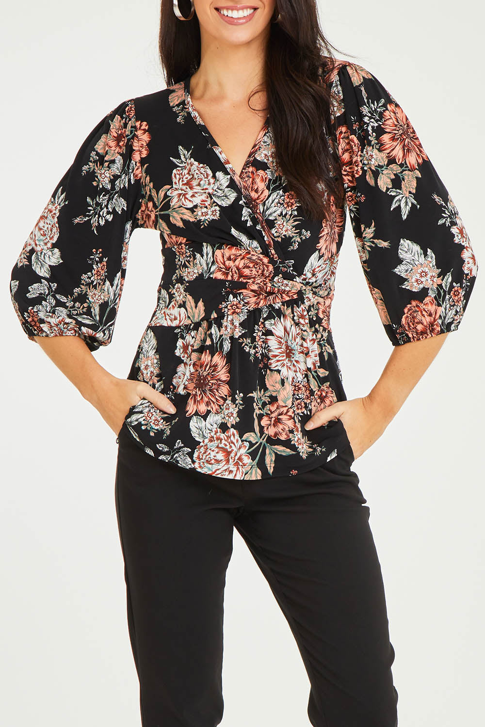 Model Stacey wearing size 10 of The Knot Waist Detail Blouse in colour Blackfleur (Black), from the front, cropped image