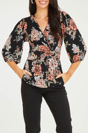 Model Stacey wearing size 10 of The Knot Waist Detail Blouse in colour Blackfleur (Black), from the front, cropped image
