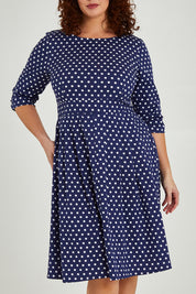 Model Maddy wearing size 16 of The 3/4 Sleeve Cotton Stretch Dress in colour Spots (Blue), from the front, cropped image