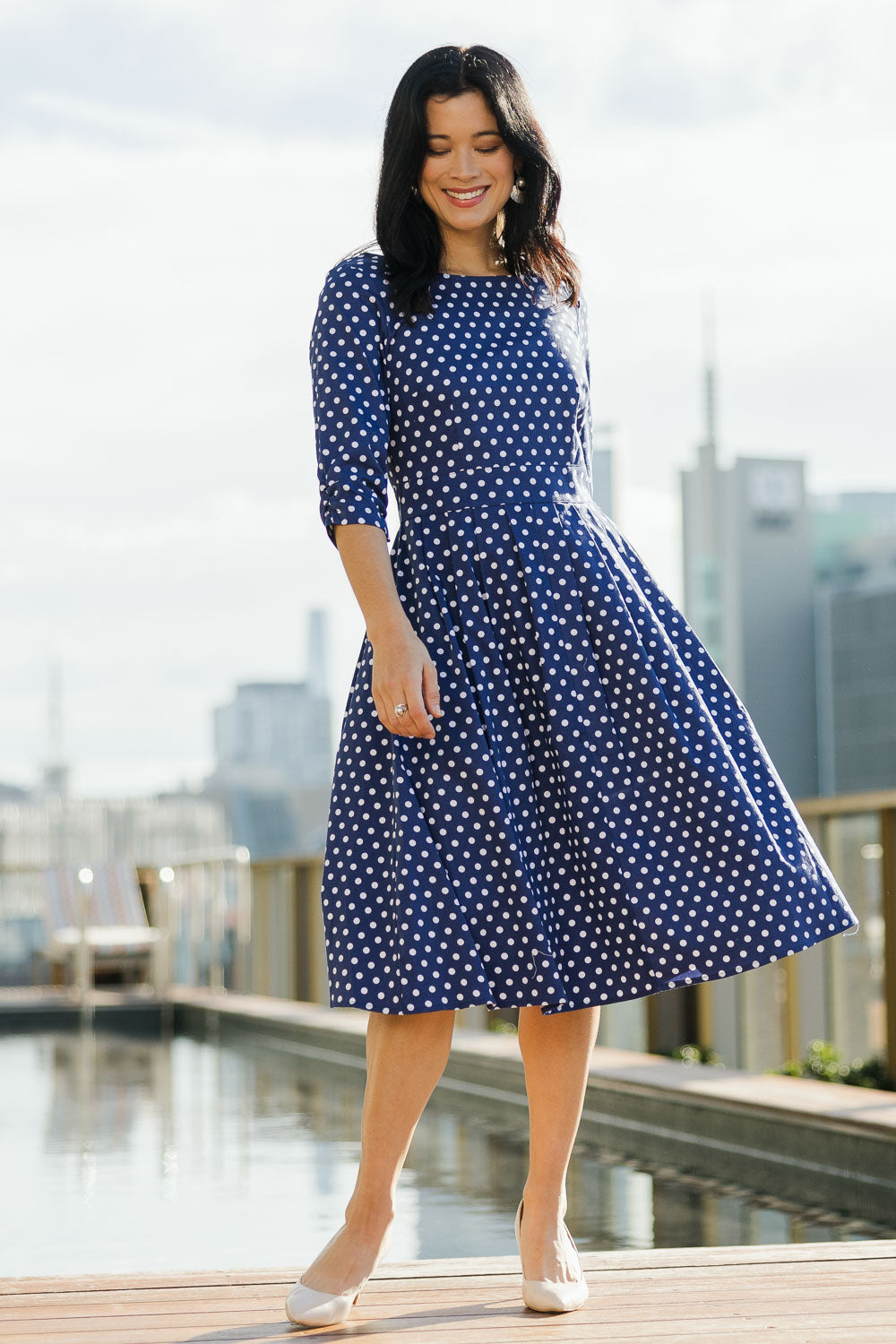 Model Miranda wearing size 10 of The 3/4 Sleeve Cotton Stretch Dress in colour Spots (Blue), from the front, showing the whole outfit