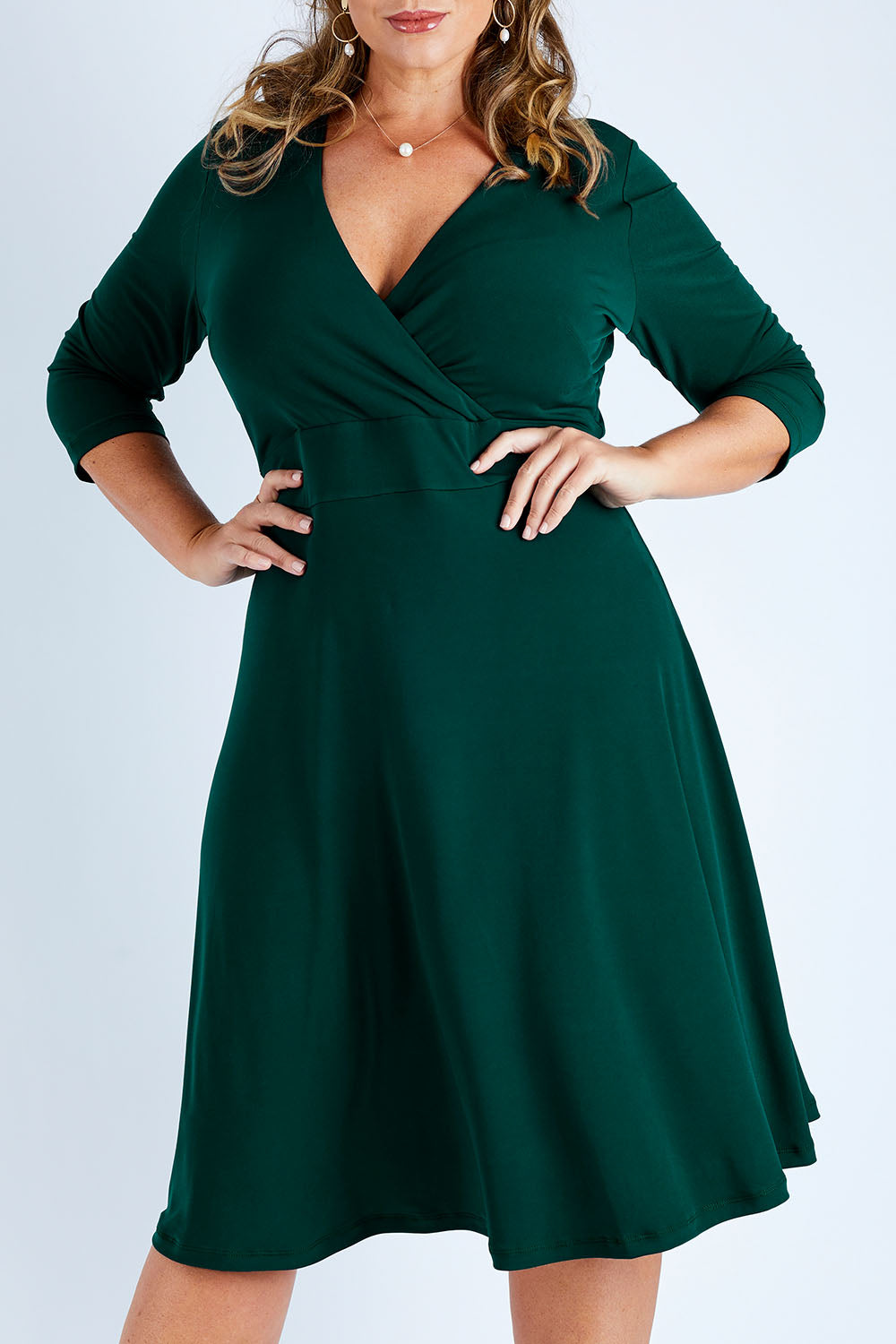 Model Fiona wearing size 16 of The Faux Wrap Jersey Dress in colour Pine (Green), from the front, cropped image