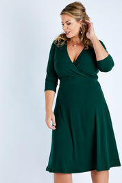 Model Fiona wearing size 16 of The Faux Wrap Jersey Dress in colour Pine (Green), from the front, cropped image
