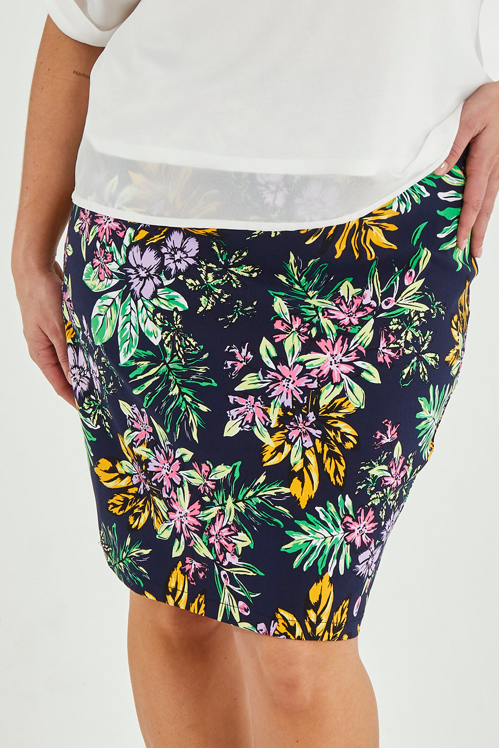 Model Maddy wearing size 16 of The Tube Skirt in colour Botanical (Blue), from the front, cropped image
