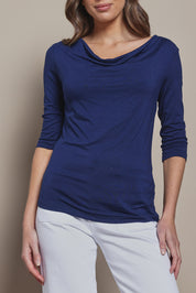 Model Madeline wearing size 10 of The Reversible Cowl Neck Top in colour Deepnavy (Blue), from the front, cropped image