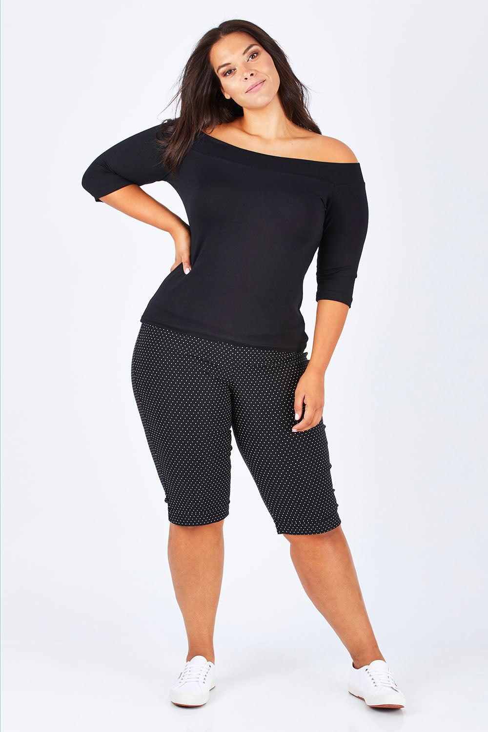 Model Lauren wearing size 16 of the Belle Knee Short in colour Spot (Black), from the front, showing the whole outfit