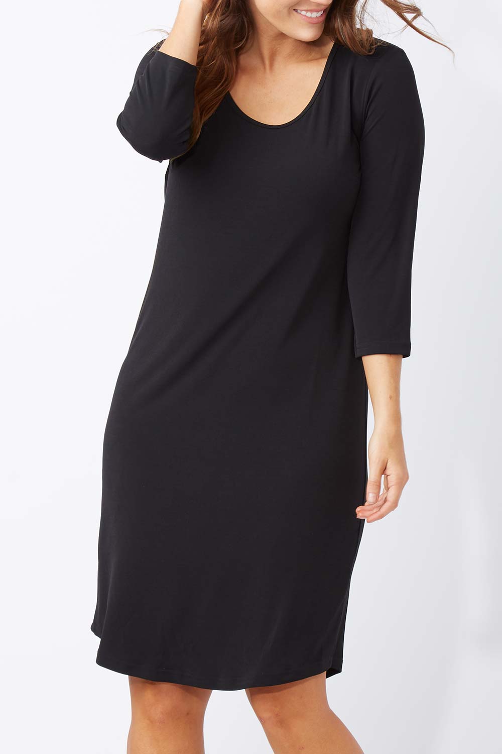 Model Laura wearing size 12 of the Belle Base Layer Dress in colour Black (Black), from the front, cropped image