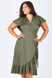 Model Lauren wearing size 16 of the Belle Ruffle Trim Dress in colour Khaki (Green), from the front, cropped image