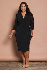 Model Ashleigh wearing size 16 of the Belle Basic Wrap Dress in colour Black (Black), from the front, showing the whole outfit