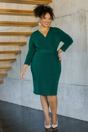 Model Alexis wearing size 18 of the Preloved Belle Basic Wrap Dress in colour Pine (Green), from the front, showing the whole outfit
