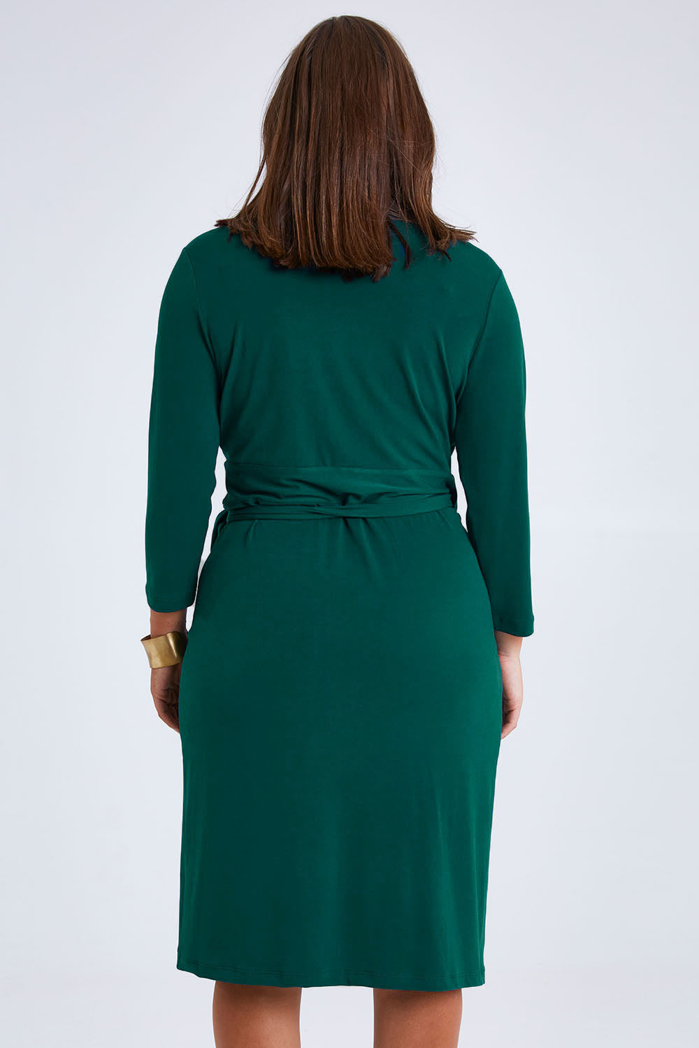 Model Monique wearing size 14 of the Belle Basic Wrap Dress in colour Pine (Green), from the back