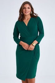 Model Monique wearing size 14 of the Belle Basic Wrap Dress in colour Pine (Green), from the front, cropped image