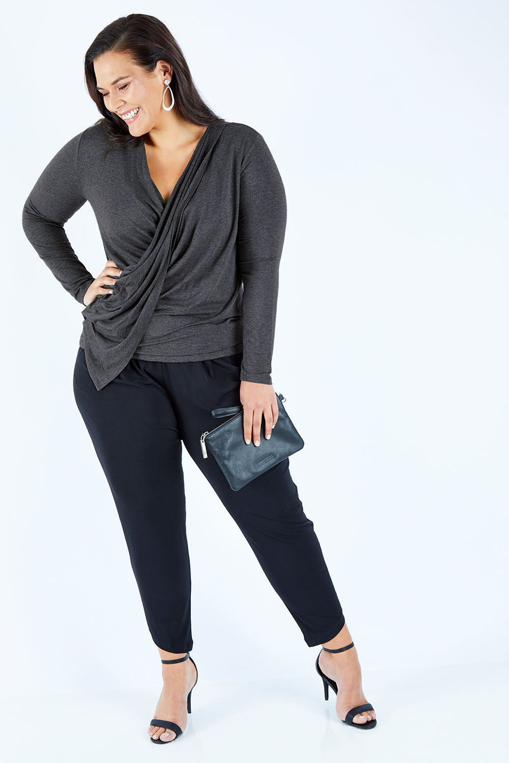Model Lauren wearing size 16 of the Belle Drape Top in colour Charcoal (Grey), from the front, showing the whole outfit
